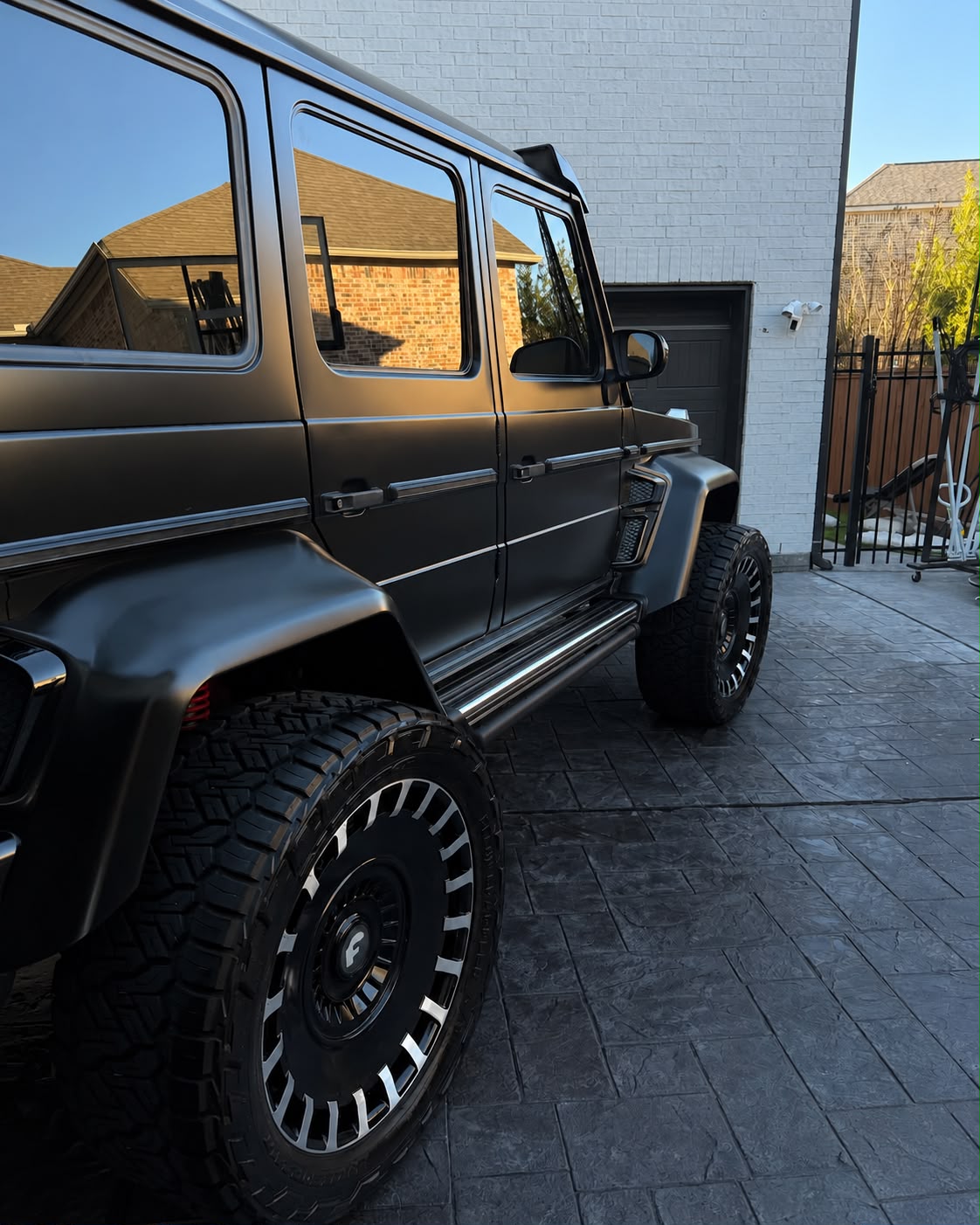 Side profile of a detailed matte black Brabus style G-Wagon